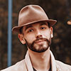 Portrait of a bearded man in a brown fedora hat