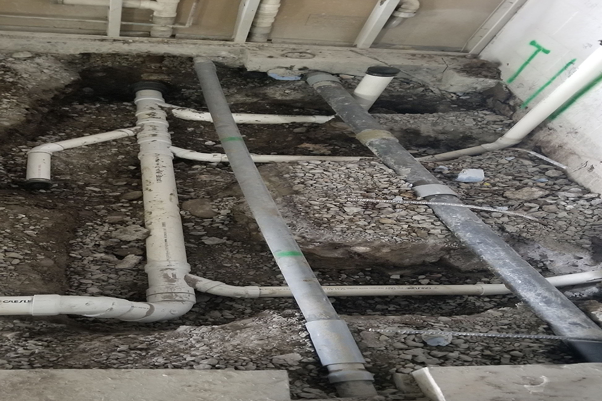 My Guy Plumbing crawl space showing drain and sewer pipes under a floor in Bozeman MT